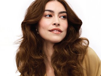 A woman with rich, glossy, medium-brown hair.