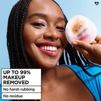 Smiling woman with braided hair holding a cotton pad near her face, captioned "Up to 99% Makeup Removed, No harsh rubbing, No residue."