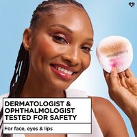Smiling woman holding a cotton pad near her eye, captioned "Dermatologist & Ophthalmologist Tested for Safety, for face, eyes & lips."