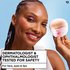 Smiling woman holding a cotton pad near her eye, captioned "Dermatologist & Ophthalmologist Tested for Safety, for face, eyes & lips."