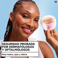 Smiling woman holding a cotton pad near her eye, captioned "Dermatologist & Ophthalmologist Tested for Safety, for face, eyes & lips.