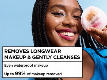 Smiling woman holding a used makeup pad to demonstrate the effectiveness of Micellar Water Waterproof in removal of long-wear and waterproof makeup, featuring text that notes up to 99% of makeup removed.