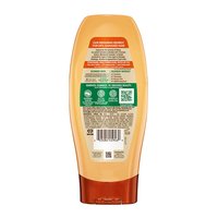 Back label of Garnier Whole Blends Honey Treasures Repairing Conditioner: showing full ingredient list, directions for use, and sustainable 'Greener Beauty' commitments.