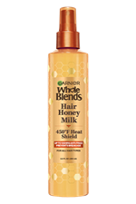 A front visual of the Garnier Whole Blends Honey Treasures Repairing Milk Honey Spray bottle.