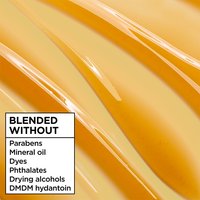 Garnier Whole Blends Hair Honey serum texture: macro shot of the smooth honey-infused formula blended without parabens, mineral oil, dyes, phthalates, or drying alcohols.