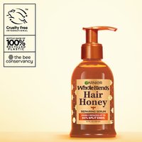 Garnier Whole Blends Hair Honey Repairing Serum for damaged hair: 5.1 fl oz pump bottle visibly reduces up to 94% of split ends, featuring 100% recycled plastic packaging and cruelty-free certification.