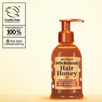 Garnier Whole Blends Hair Honey Repairing Serum for damaged hair: 5.1 fl oz pump bottle visibly reduces up to 94% of split ends, featuring 100% recycled plastic packaging and cruelty-free certification.