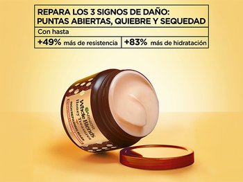 Garnier Whole Blends Honey Treasures Rich Repairing Mask jar with open lid, featuring text highlighting repair for split ends, breakage, and dryness with +49% more strength and +83% more moisture.