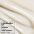 Macro texture of creamy white Garnier Whole Blends Miracle Nectar leave-in treatment, blended without parabens, phthalates, mineral oil, or DMDM hydantoin.