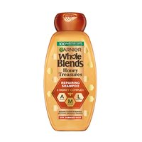 Garnier Whole Blends Honey Treasures Repairing Shampoo bottle for dry, damaged hair: 12.5 fl oz packaging featuring a 3 honey complex of acacia, manuka, and lavender honey to repair split ends, breakage, and dryness.