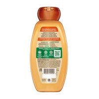 Back view of Garnier Whole Blends Honey Treasures Repairing Shampoo bottle: showing full ingredient list, directions for use, and greener beauty commitments including responsible sourcing.