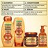 Complete Garnier Whole Blends Honey Treasures repairing system: 4-step routine including repairing shampoo, conditioner, rich repairing mask, and hair honey serum for healthy, moisturized hair.