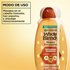 How to use Garnier Whole Blends Repairing Shampoo: product demonstration showing the rich, creamy lather being dispensed for a thorough massage into wet hair.