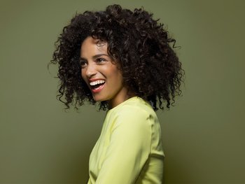 A woman with brown-black hair is featured.