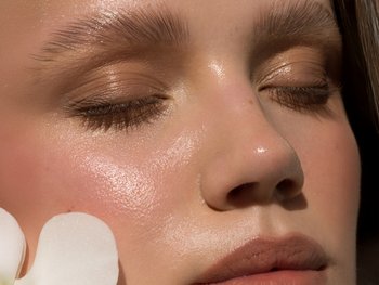 A close-up of a nose with visible shine, depicting oily skin.