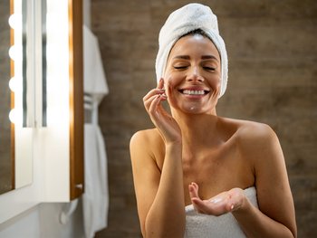 Women putting a cleanser on her face