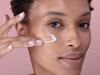Woman washing her face with face wash.