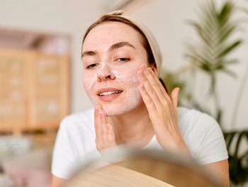 woman exfoliating skin