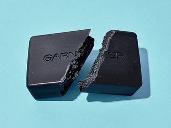 A broken bar of charcoal soap.