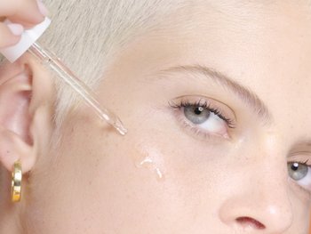 Applying serum with a dropper.