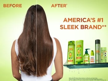 A split image advertisement for hair products. The left side shows the back of a woman with long, brownish, frizzy hair, labeled "BEFORE". The right side shows the same woman with noticeably smoother, straighter, and shinier hair, labeled "AFTER". To the right of the woman, a collection of green-bottled Garnier Fructis Sleek & Shine hair products is displayed on a glass shelf. Above the products, large orange text proclaims "AMERICA'S #1 SLEEK BRAND**". Small disclaimer text is visible at the very bottom right.