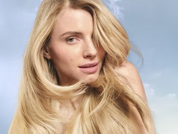 A woman with long, straight blond hair.