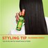 Styling tip: woman with shiny, straight, black hair holding Brilliantine Shine Glossing Spray bottle.